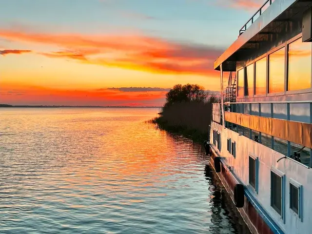 Ibis Tours 4-star floating hotel moored in the Danube Delta at sunset — Romania