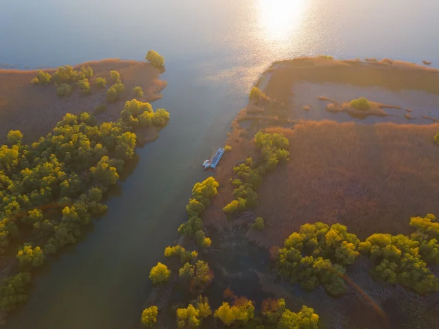 Aerial view of Ibis Tours floating hotel surrounded by Danube Delta autumn landscape — 5-day wildlife cruise Romania