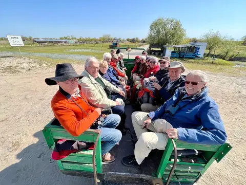 Tour group on a traditional horse-drawn cart arriving at Letea village, Danube Delta